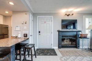 a living room with a fireplace and a tv at Mountainside Resort Condo at Blue in Blue Mountains