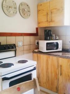 a kitchen with a white stove and a microwave at Dullstroom on the Dam in Dullstroom +26 photos