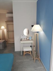 um quarto com uma mesa com um espelho e um candeeiro em A cà ed Franca e Giaco em La Morra