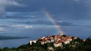 a rainbow over a town on top of a hill at Villa Frane 101 in Beli
