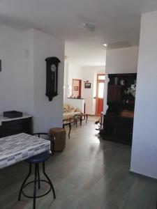 a living room with a table and a clock on the wall at Villa Frane 101 in Beli