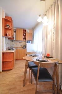 a kitchen with a wooden table and a dining room at Grafovi Apartments in Narva