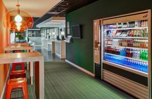 a fast food restaurant with a refrigerator filled with drinks at Holiday Inn Express Utrecht - Papendorp, an IHG Hotel in Utrecht