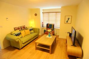 a living room with a couch and a table at EasyTravel Luxury NEC/Airport 3 beds House in Birmingham