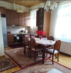 a kitchen with a dining room table with chairs at Tzelati Vytinas in Vitina