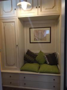 a built in bench with pillows in a cabinet at Appartamento Pescoluce in Pescocostanzo