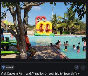 a picture of a pool with people in the water at Spanish Palm Villa in Spanish Town
