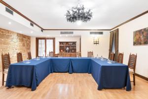 a large room with a long table with blue tables at Eurostars Los Agustinos in Haro