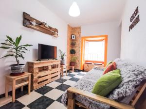 a living room with a couch and a tv at Casa Poema Next To River Tejo & Zêzere in Constância