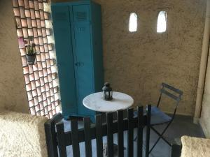 a small table and a chair in a room at location studio traversant , lit King size,2 terrasses in Sausset-les-Pins +4 photos