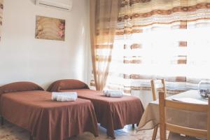 a room with two tables and a window at B&B Nettuno in Messina