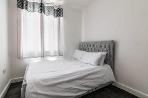 a small bedroom with a bed with a window at Fantastic brand new Rooms in Bury