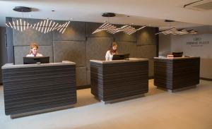 two women sitting at a counter with their laptops at Crowne Plaza Basingstoke by IHG in Basingstoke