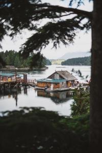 a house on a dock on a lake at The Shoreline Tofino in Tofino