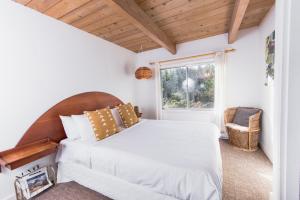 A bed or beds in a room at The Shoreline Tofino