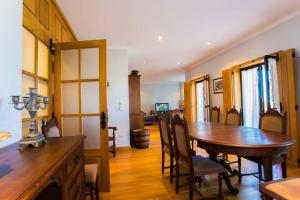 a dining room with a wooden table and chairs at Quinta da Mesquinhata in Lamego