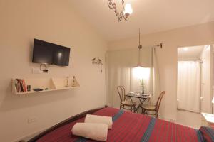 a bedroom with a bed and a living room with a table at Loft para 2 personas in San Salvador de Jujuy