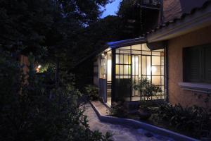 a house with a lit up window at night at Loft para 2 personas in San Salvador de Jujuy