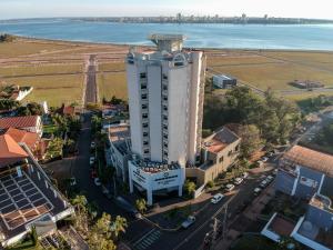 an aerial view of a tall white building on a street at De la Trinidad Hotel in Encarnación