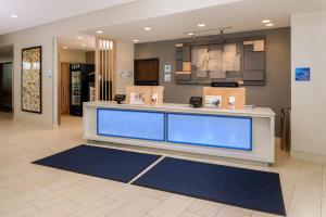 a lobby with a reception desk in a building at Holiday Inn Express & Suites Alachua - Gainesville Area, an IHG Hotel in Alachua