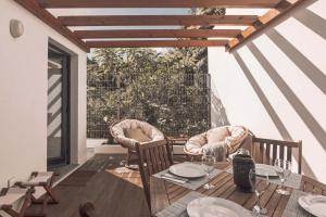 a dining room with a table and chairs on a patio at 9 Furnas Villa in Furnas