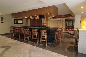 a kitchen with a bar with wooden stools at Holiday Inn Monterrey Norte, an IHG Hotel in Monterrey