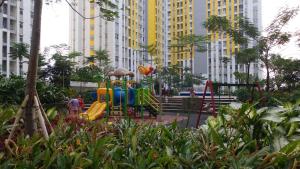 a playground in the middle of a city with tall buildings at Modern and Full Parquette Studio Springlake Summarecon Bekasi Apartment By Travelio in Bekasi