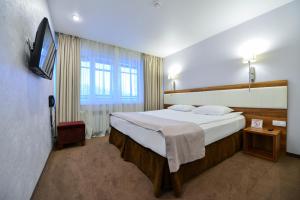 Кровать или кровати в номере Чайка Отель