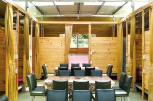 a room with a table and chairs in it at Shuitianfarm in Jianshi