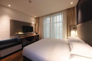 Postel nebo postele na pokoji v ubytování Holiday Inn Express Hefei Shushan by IHG