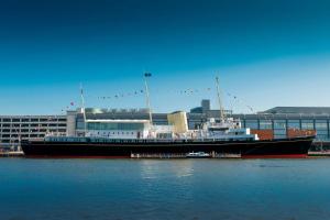 a large boat docked in the water in front of a building at Holiday Inn Express Edinburgh - Leith Waterfront by IHG in Edinburgh