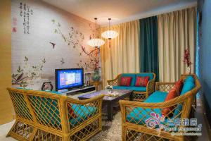 a living room with chairs and a tv and a table at Floral Elegance1 @ Galacity in Kuching