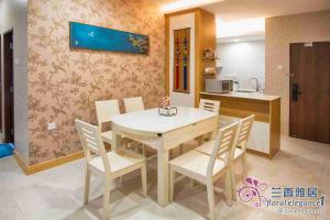 a dining room with a white table and chairs at Floral Elegance1 @ Galacity in Kuching