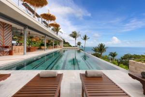 an infinity pool in a villa with the ocean in the background at Kapuhala Koh Samui- Vegan Boutique Hotel in Chaweng Noi Beach