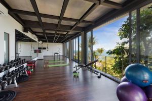 a gym with a view of the ocean at Kapuhala Koh Samui- Vegan Boutique Hotel in Chaweng Noi Beach