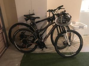 a black bike parked in a room with a basket at Observation Holiday Home in Paraparaumu Beach