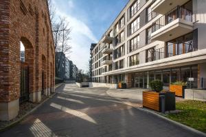 an empty street in a city with buildings at Rakowicka Top Apartaments Superior in Krakow