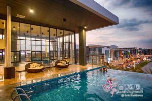 a pool in a building with people swimming at Floral Elegance1 @ Galacity in Kuching
