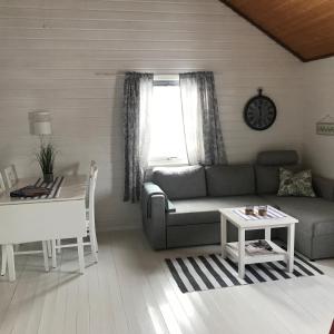 a living room with a couch and a table at Ludvigbua in Stamsund