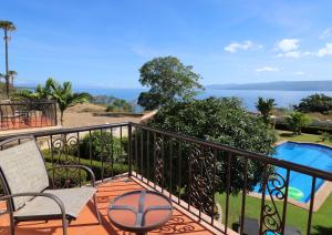 a balcony with a table and chairs next to a pool at Star View Boutique Resort in Dumaguete