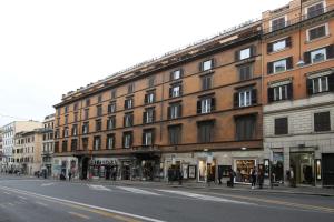a large brick building on the side of a street at La Maisonnette Tritone Trevi Apartment Rome in Rome
