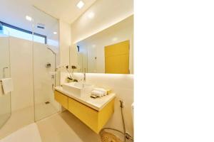 a bathroom with a sink and a shower at Clean & Quiet Villa - The Point Resort in Da Nang