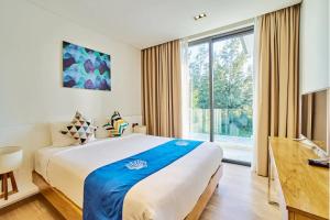 a bedroom with a large bed and a large window at Clean & Quiet Villa - The Point Resort in Danang +290 photos