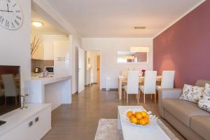 a living room with a couch and a table at Luxury Apartments Villa Mande in Malinska