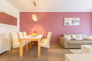 a living room with a table and a couch at Luxury Apartments Villa Mande in Malinska