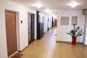 an empty hallway with a potted plant in a building at TiTo in Belgrade