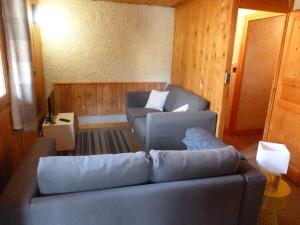 a living room with a couch and two chairs at Chalet Le Cordava in Tignes
