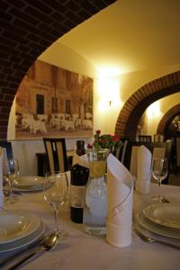 a table with a bottle of wine and glasses at Polonia Raciborz in Racibórz