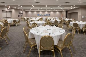 a conference room with white tables and chairs at Holiday Inn Marquette by IHG in Marquette +59 photos
