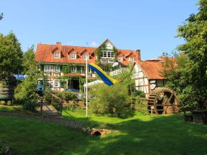 a house with a slide in front of a yard at Landgasthof und Landhaus Hofmeister in Diemelsee